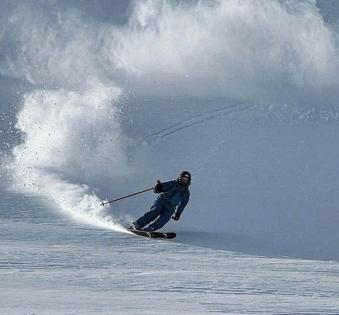 Skier embracing the lush powser in Siberia