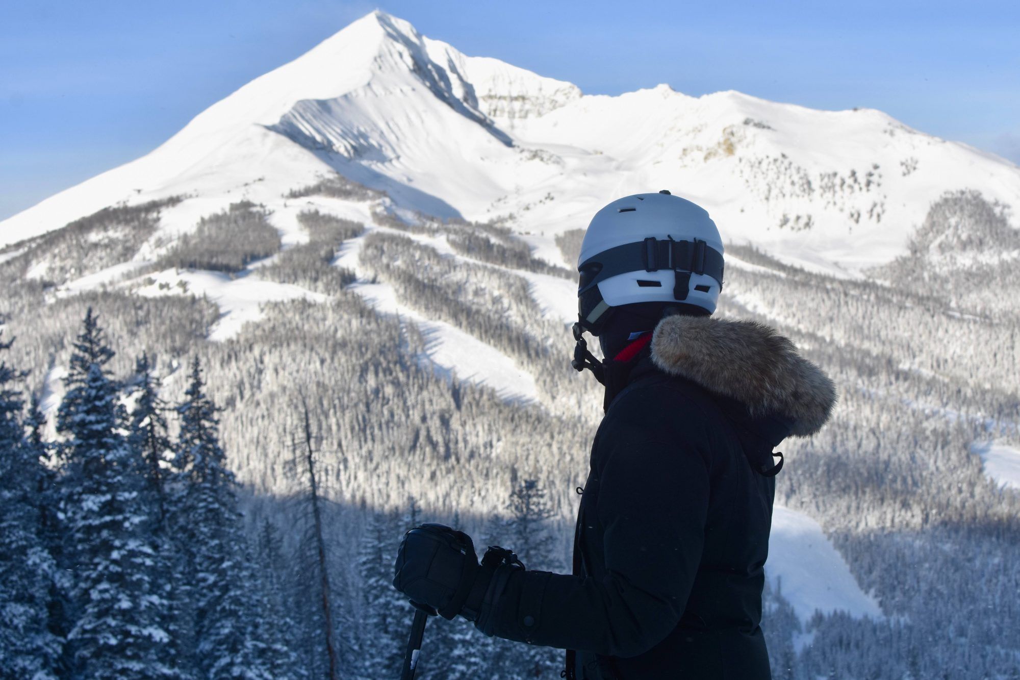 Female-skier-in-fur-coat-looking-out-at-Big-Sky-Ski-Resort-in-Montan