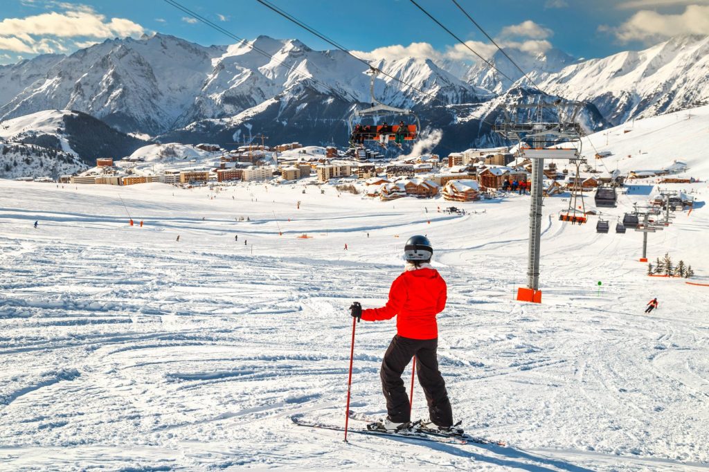 Alpe d’Huez 2 Wonderful famous ski resort with skiers in high mountains, Alpe d Huez, France