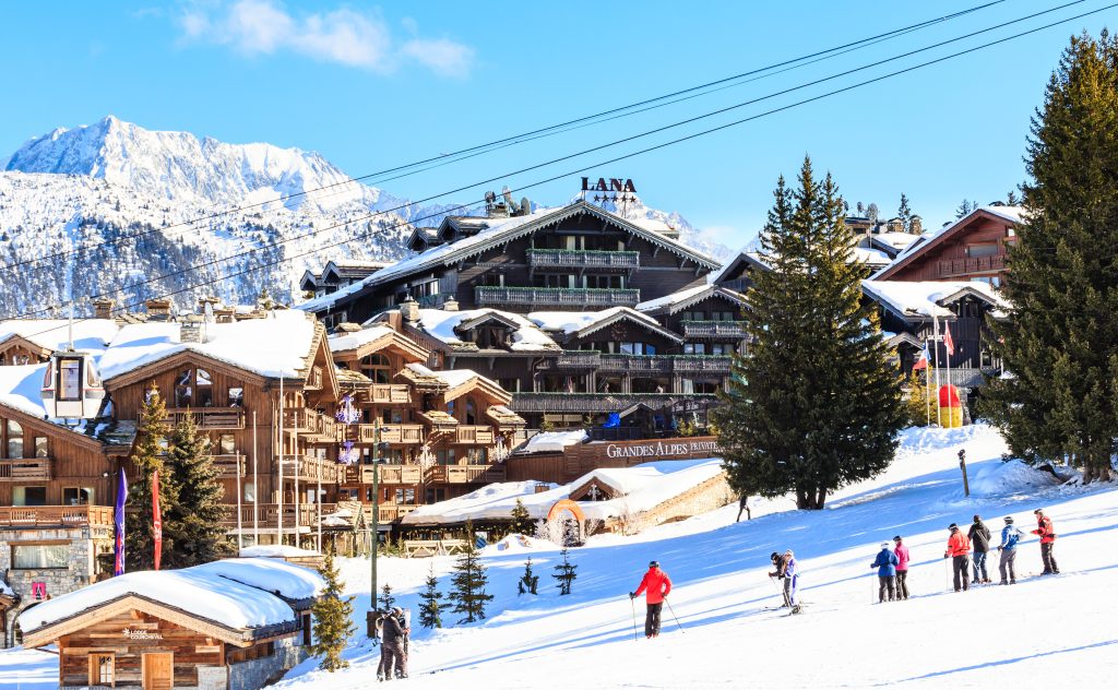 a group of people skiing on a snowy mountain at Courchevel